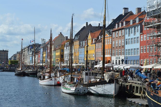 Wooden boats moored against the painted houses of Nyhavn, Copenhagen